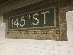 Gros plan sur cartouche en mosaïque, inscription 145thST.