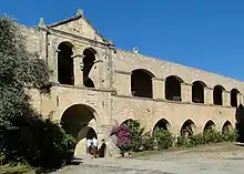 photographie couleurs : un bâtiment à deux étages d'arcades