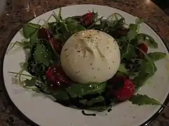 Avec burrata, roquette, et huile d'olive.