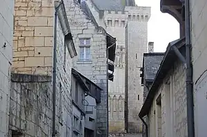 Photographie en couleurs de bâtiments construits en moyen appareil de pierre de taille blanche.