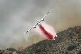 Un Tracker S-2FT du CAL FIRE (en) larguant du retardant.