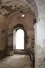 La nef. À droite au premier plan, le piédroit nord. On distingue en haut l'arc triomphal et derrière la voûte de la nef, ainsi que la porte et l'oculus.