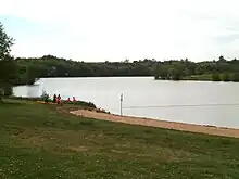 Vue d'un plan d'eau aménagé en base de loisirs.