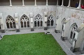 Photo prise de plongée d'un cloître avec un carré de verdure au centre