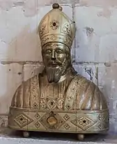 Photographie de face d'un objet en bois doré.