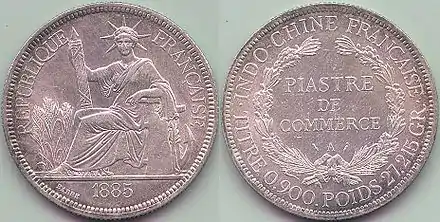 Une « piastre de commerce » de 1885 (27,215 g d'argent à 900 ‰).