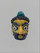 Tête d'homme barbu, pendentif, IVe – IIIe siècle av. J.-C., production carthaginoise. Metropolitan Museum.