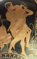 Vase antique à fond noir : deux hommes luttant.