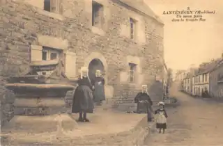 Lanvénégoises posant à côté du vieux puits de la grande rue (actuelle rue Jean Cadic) .