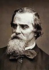 Portrait photographique sépia d’un homme âgé barbu.