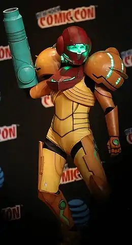 Femme dans un costume de Samus Aran de couleur jaune et rouge (cosplay).