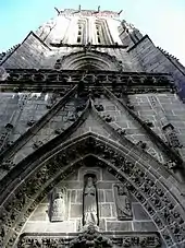 Photographie d'une tour avec un tympan, prise juste au pied