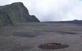 Le Formica Leo au fond de l'Enclos Fouqué avec le piton de Partage en arrière-plan.