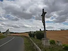 Le calvaire sur la D 61 avec l'église au fond.