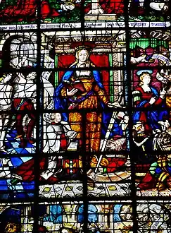 Élément de vitrail. Au centre de l'image, une femme habillée en orange porte une épée et un livre rouge. Des hommes sont agenouillés à ses pieds. À gauche, un homme barbu torse nue frappe à coups de verge une femme. Des phylactères sont visibles.