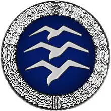 Insigne: Disque bleu entouré d'une couronne d'argent avec 3 mouettes empilées en vol Insigne d'argent