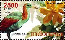 Reproduction d'un timbre horizontal représentant sur la gauche un oiseau au long bec jaune, à la tête, au ventre et au-dessus du dos verdâtres, et à l'arrière des ailes et au-dessus du cou bruns, et sur la droite une grande fleur jaune et orange.