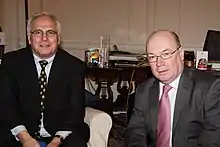 Two men seated in suits