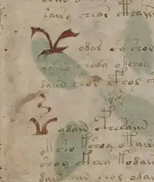 manuscrit : détail de la première page où apparaissent deux grands symboles rouges.